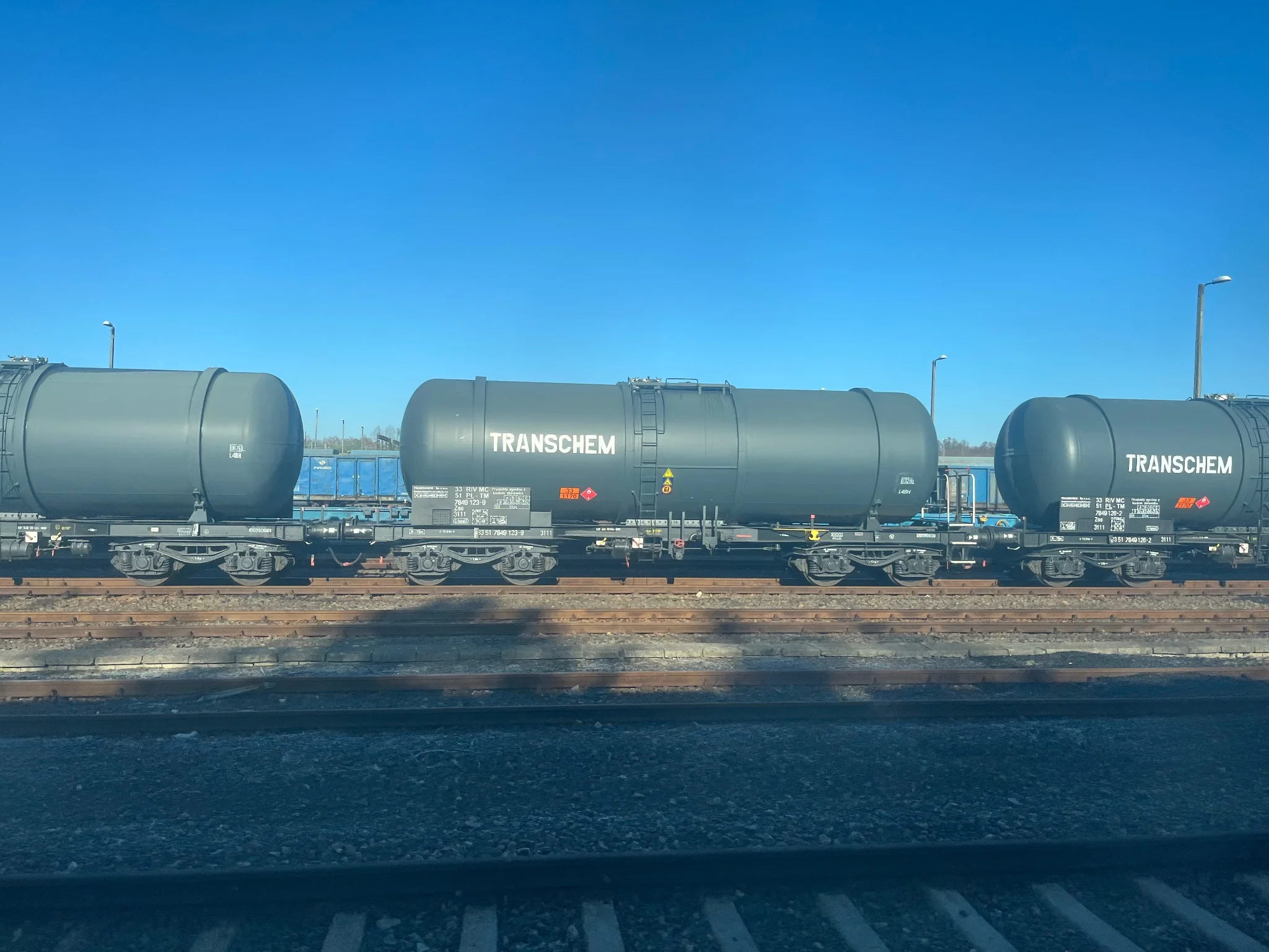 Grey tank cars saying “Transchem”